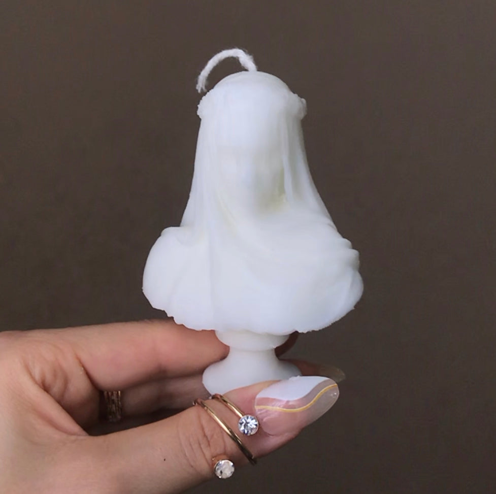 veiled woman statue candle